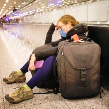 A woman rests at an airport.