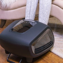 person sitting on the couch with feet in zyllion shiatsu foot massager 