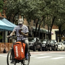Grubhub bag on a delivery bike on a street in NYC. 