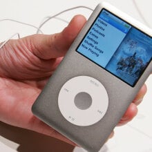 A close-up of a person holding an iPod Classic.
