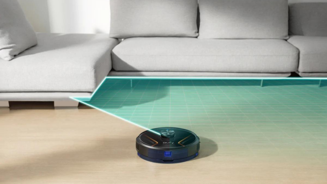 eufy robovac x8 hybrid vacuuming floor next to couch