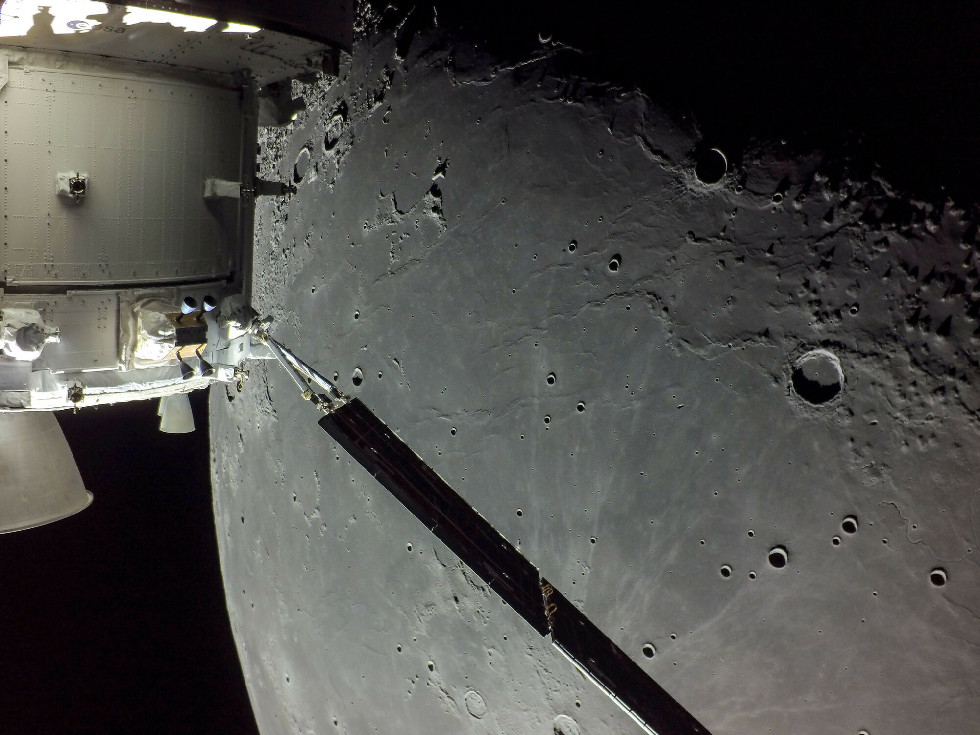 The Orion spacecraft's solar array in front of the moon