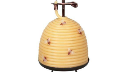 Candle shaped like beehive with little bees around it