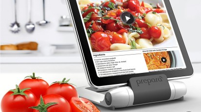 Tomatoes next to tablet on stand showing tomato recipe