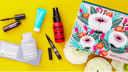 Birchbox with beauty products on yellow background
