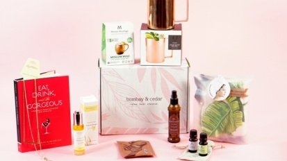 Bombay and Cedar box surrounded by wellness items on pink background