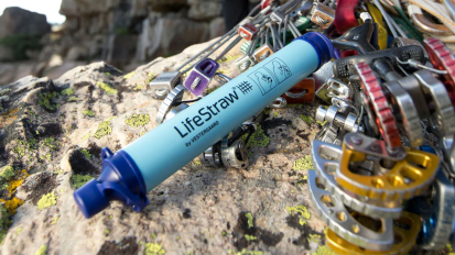 a lifestraw attached to rock-climbing equipment