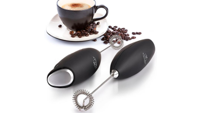 two black milk frothers set beside a cappuccino in a mug