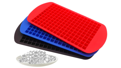 three silicone ice trays next to a bowl of ice cubes