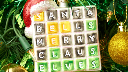 a wordle ornament hanging on a christmas tree